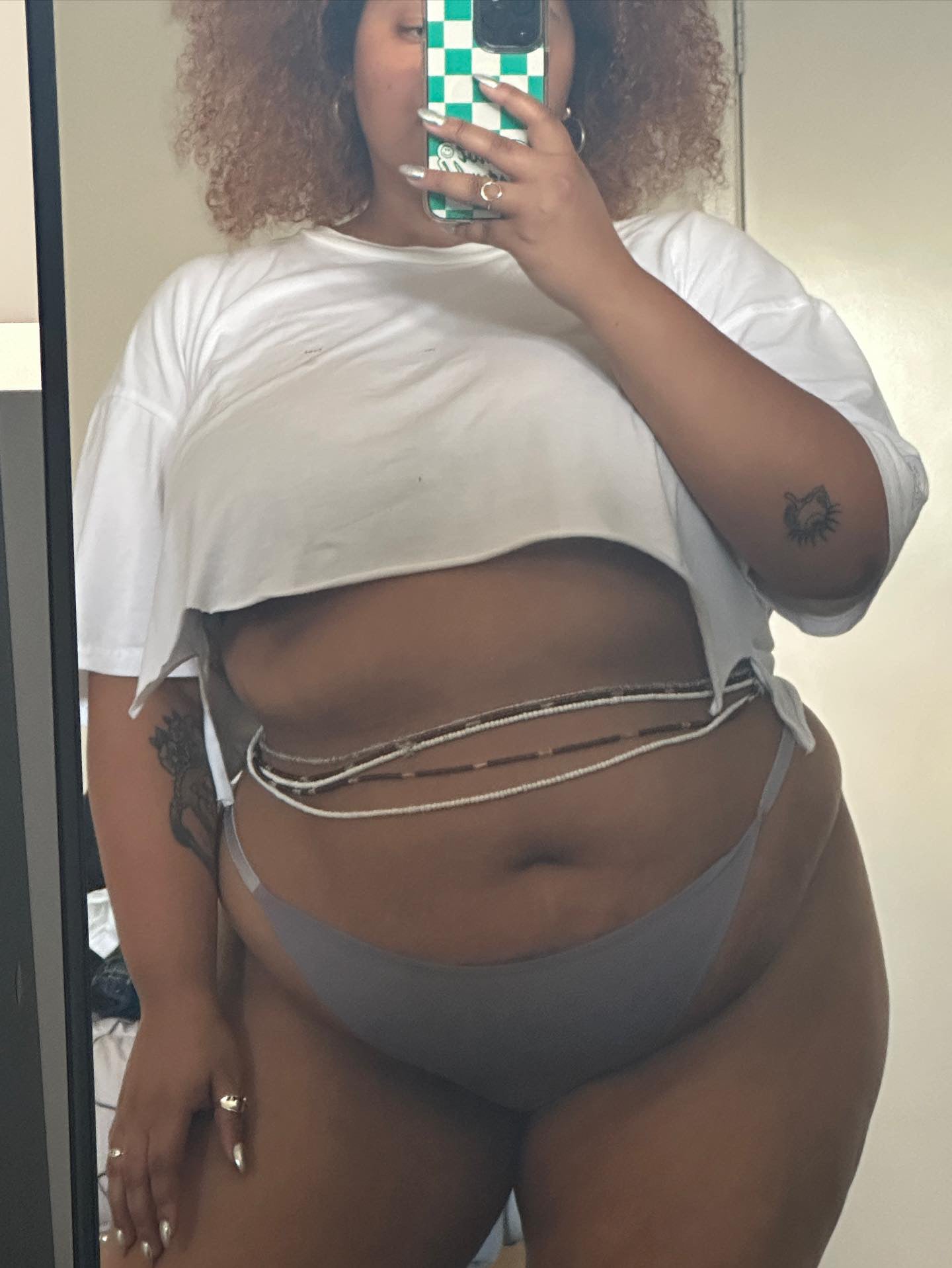 curvy black girl wearing African waist beads by Kentell