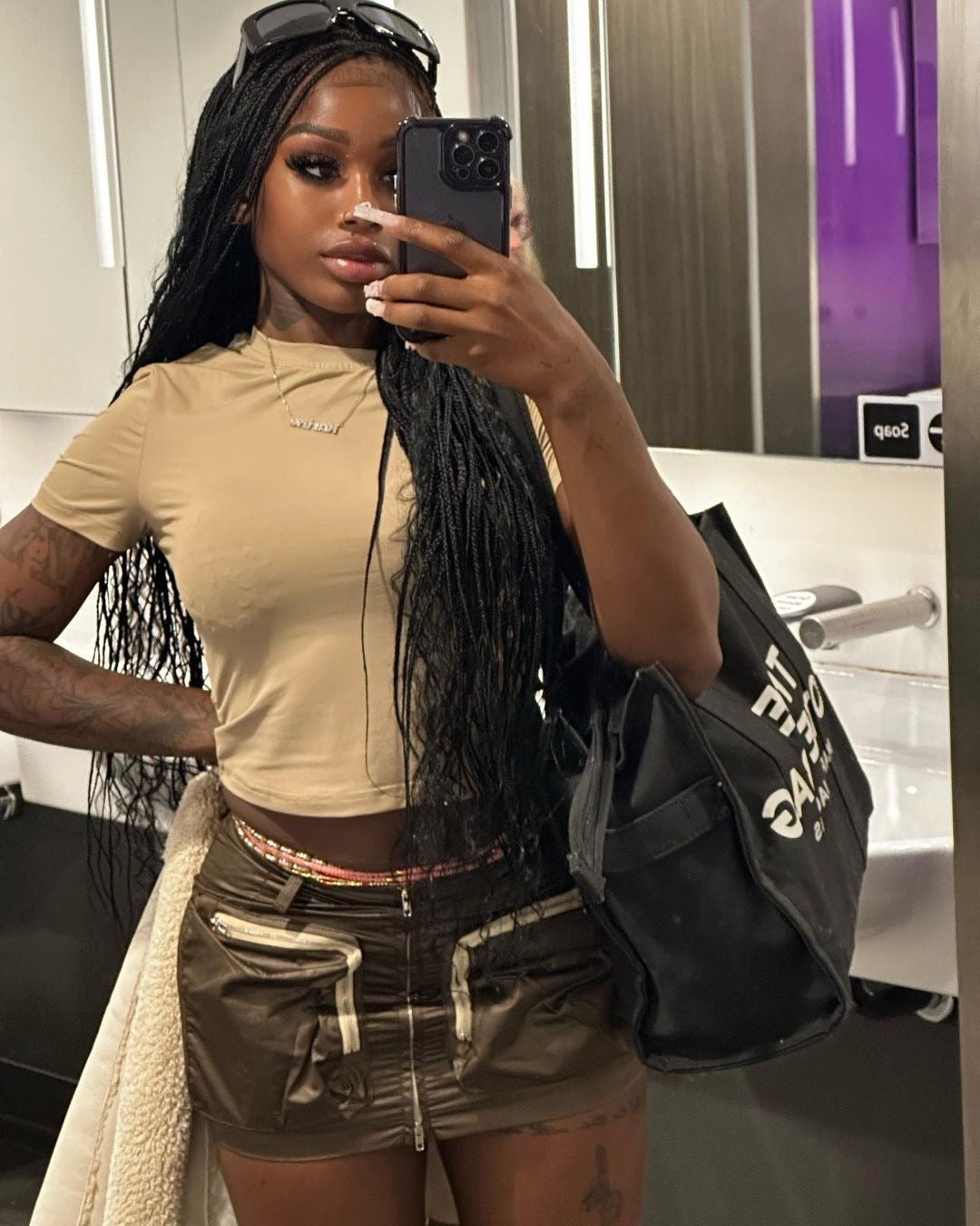 black girl wearing gold and silver waist beads. selfie