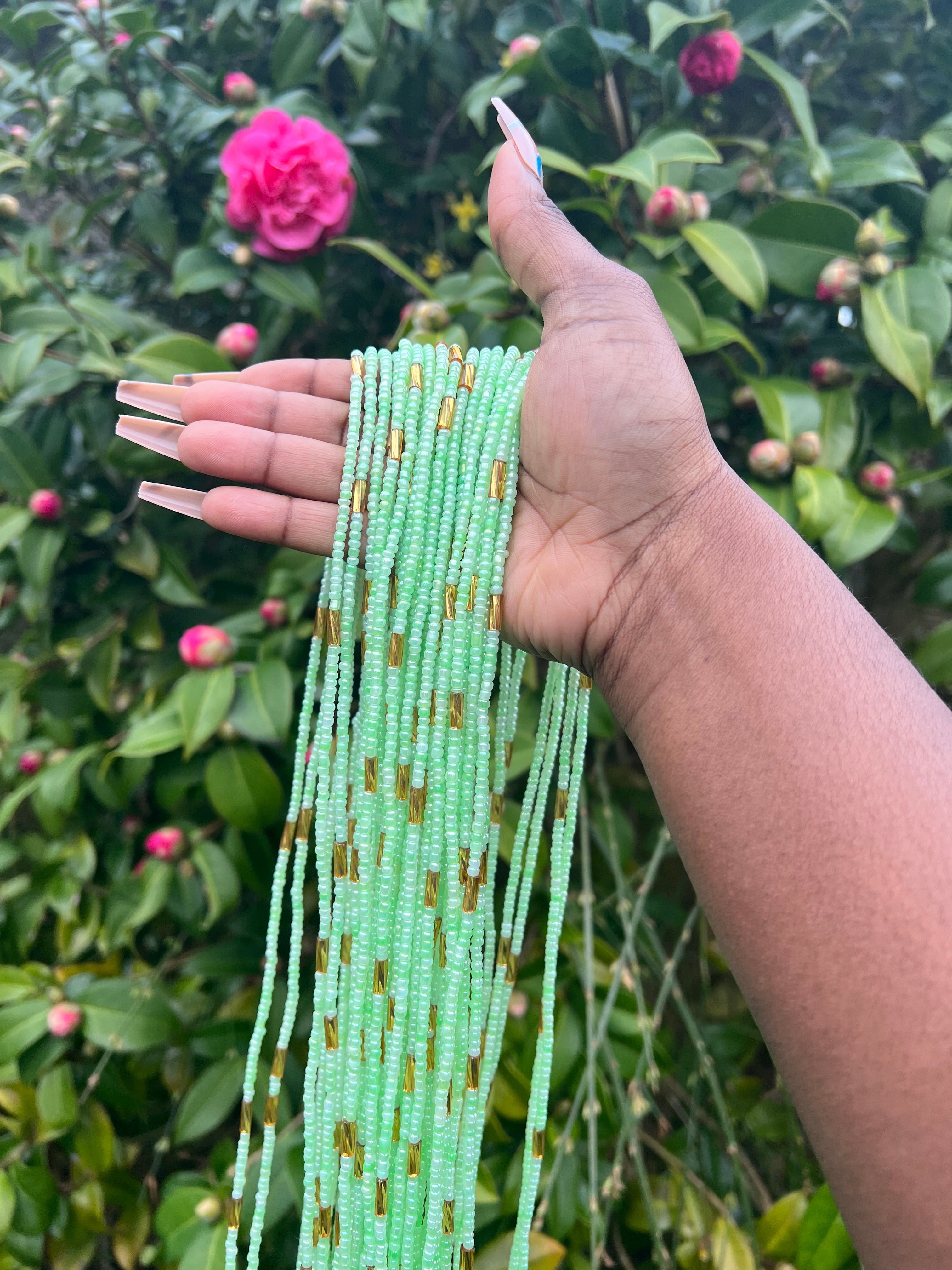 light green with gold waist beads. close up