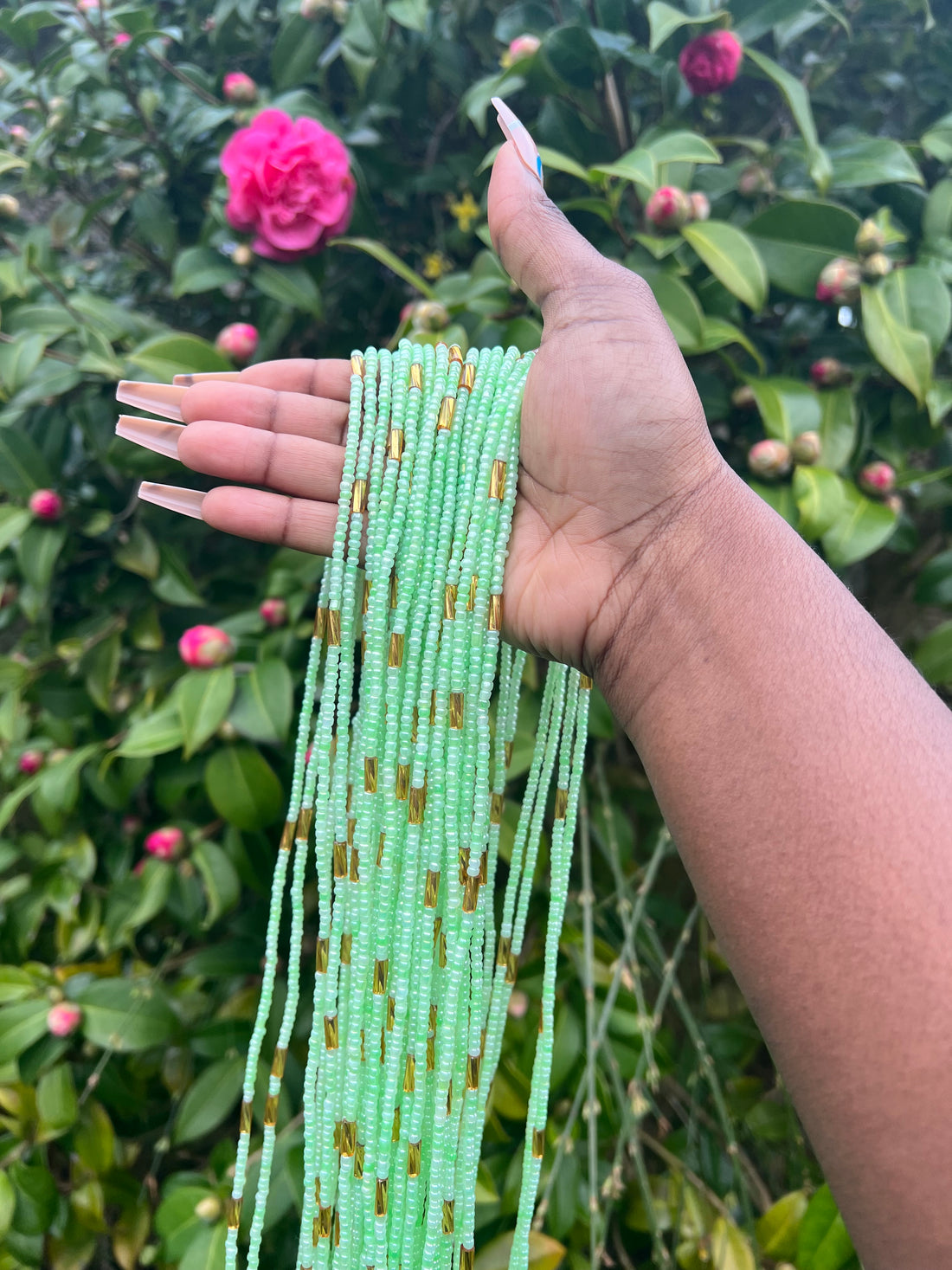 light green with gold waist beads. close up